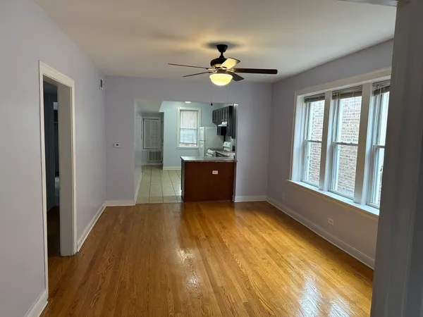 a view of livingroom with kitchen and wooden floor