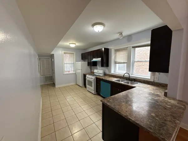 a kitchen with stainless steel appliances granite countertop a sink refrigerator and microwave
