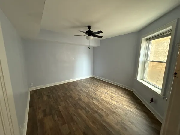 a view of empty room with ceiling fan