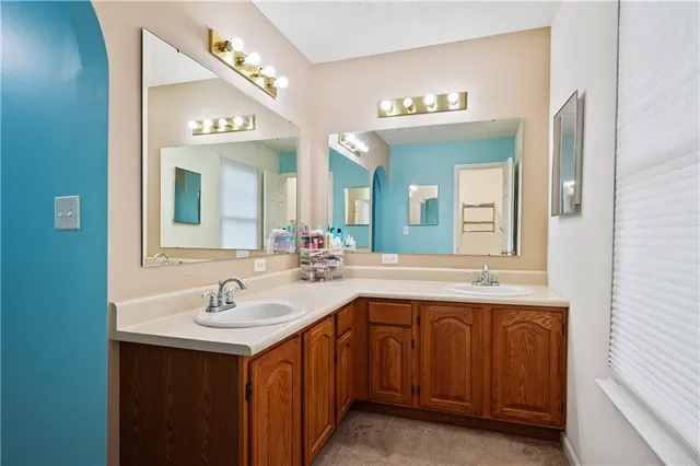a bathroom with a double vanity sink and a mirror