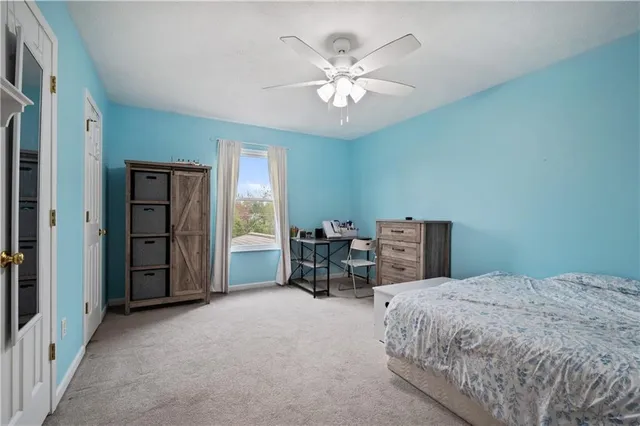 a bedroom with a large bed and a chandelier