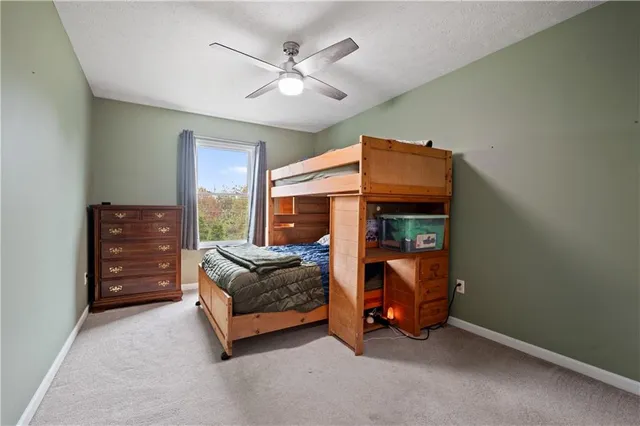 a living room with furniture and a ceiling fan