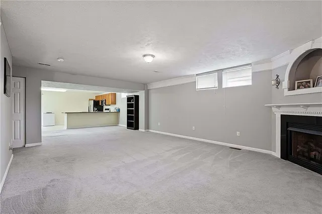 a view of empty room with a fireplace