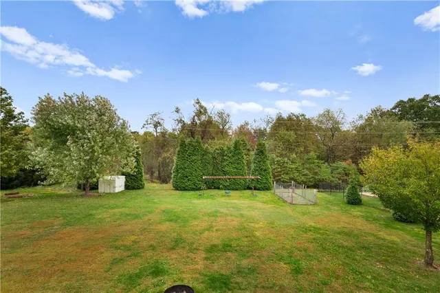 a view of a field with trees in the background