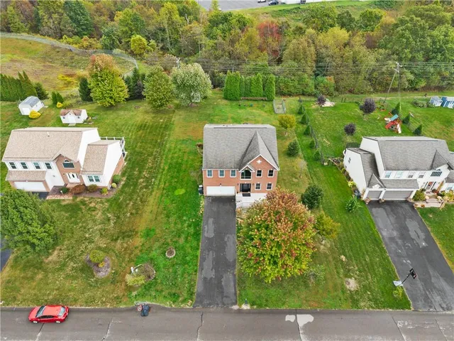 an aerial view of a house with a yard basket ball court and outdoor seating