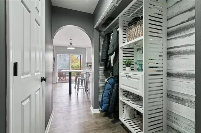 a view of a hallway view with wooden floor and staircase