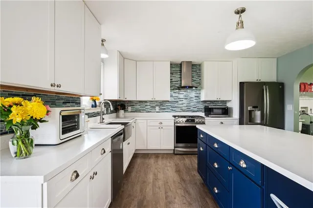 a kitchen with white cabinets and stainless steel appliances