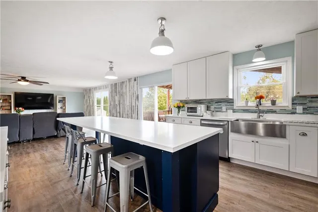 a kitchen with a table chairs sink and cabinets