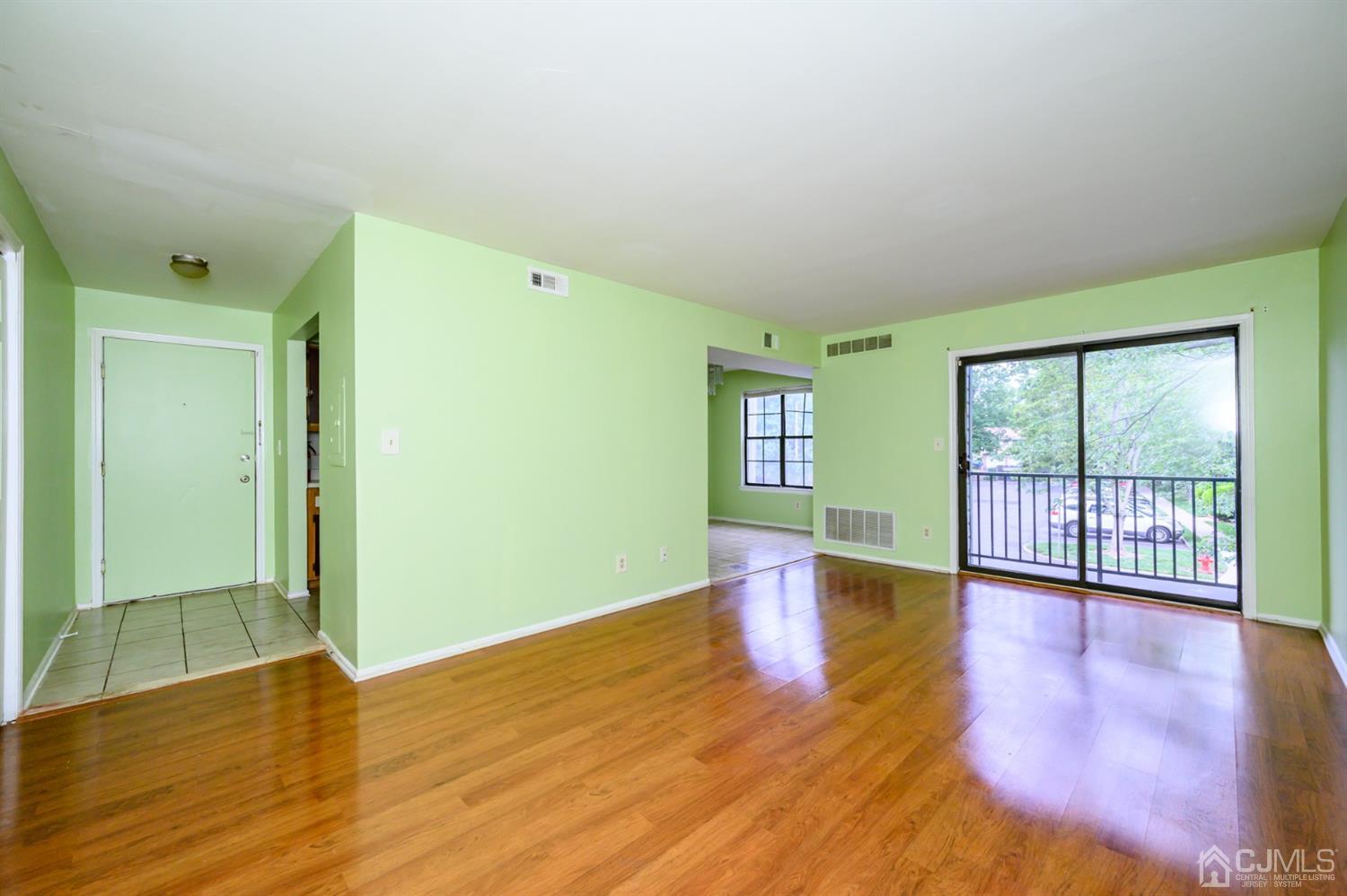 44 Boulder Drive Edison, NJ 08817 - Photo 13 of 21 an empty room with wooden floor and windows