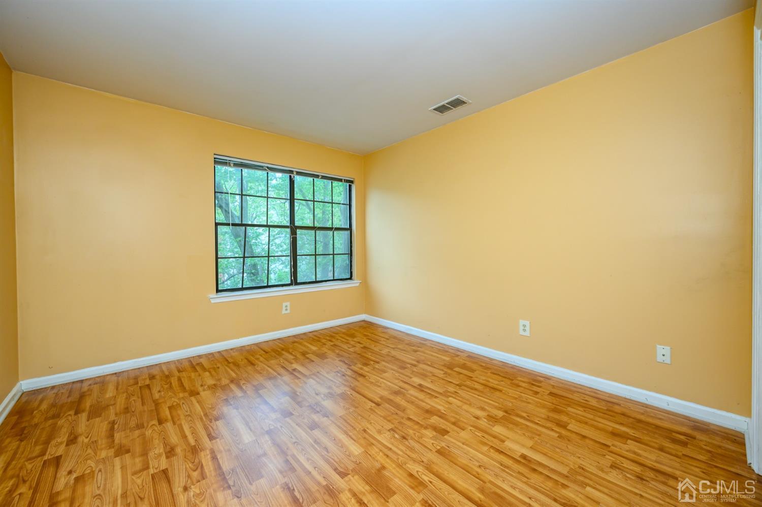44 Boulder Drive Edison, NJ 08817 - Photo 14 of 21 a view of an empty room with wooden floor and a window