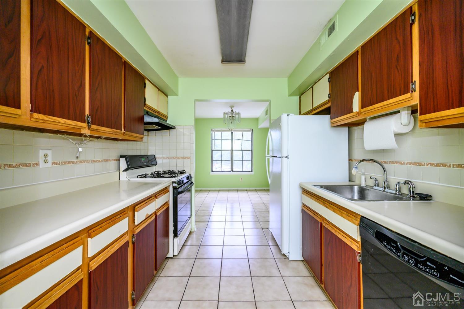 44 Boulder Drive Edison, NJ 08817 - Photo 5 of 21 a kitchen with stainless steel appliances granite countertop a sink stove and cabinets