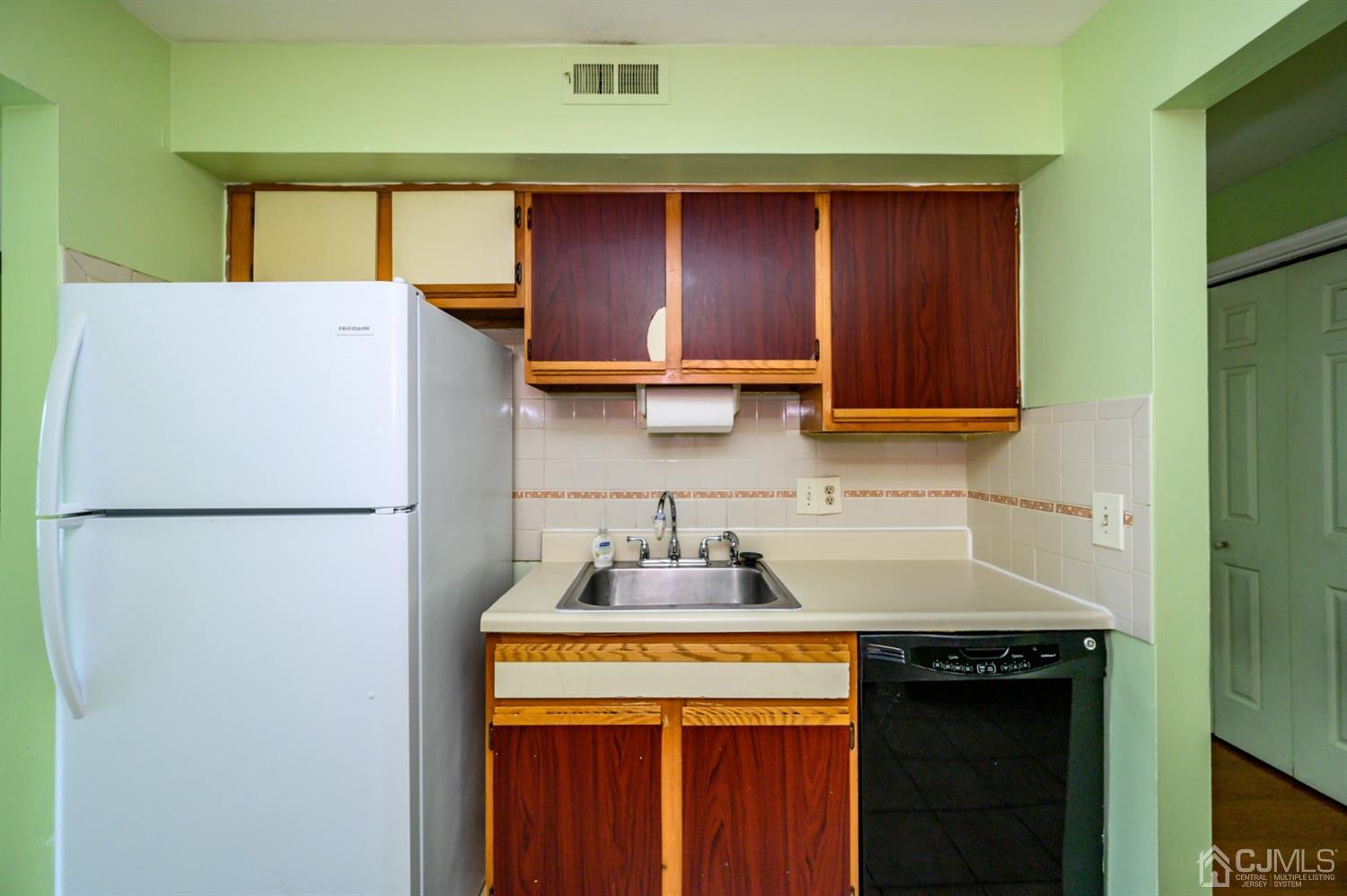 44 Boulder Drive Edison, NJ 08817 - Photo 6 of 21 a kitchen with a refrigerator and cabinets