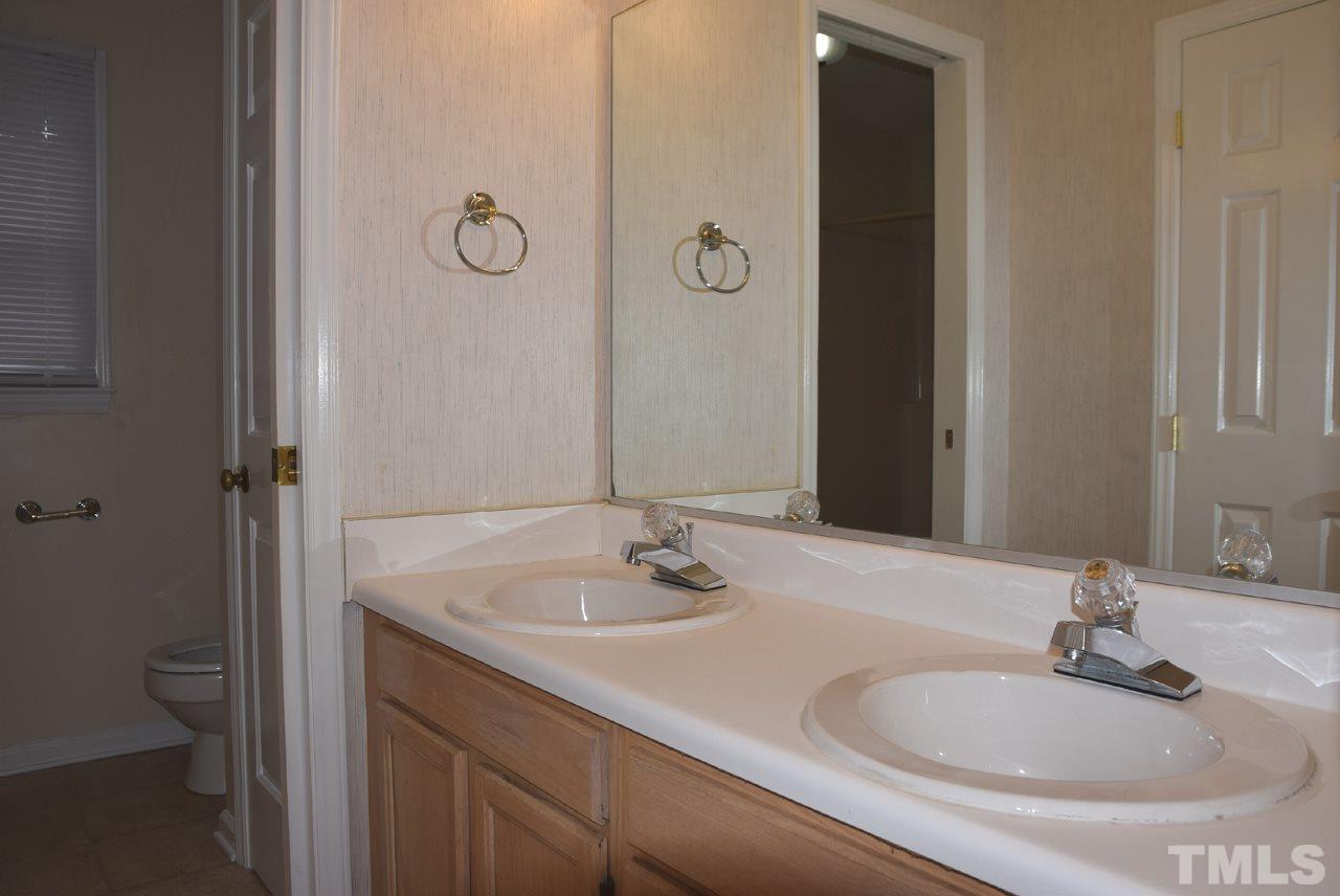 4608 Thurmount Place Raleigh, NC 27604 - Photo 14 of 30 a bathroom with a granite countertop sink and a mirror