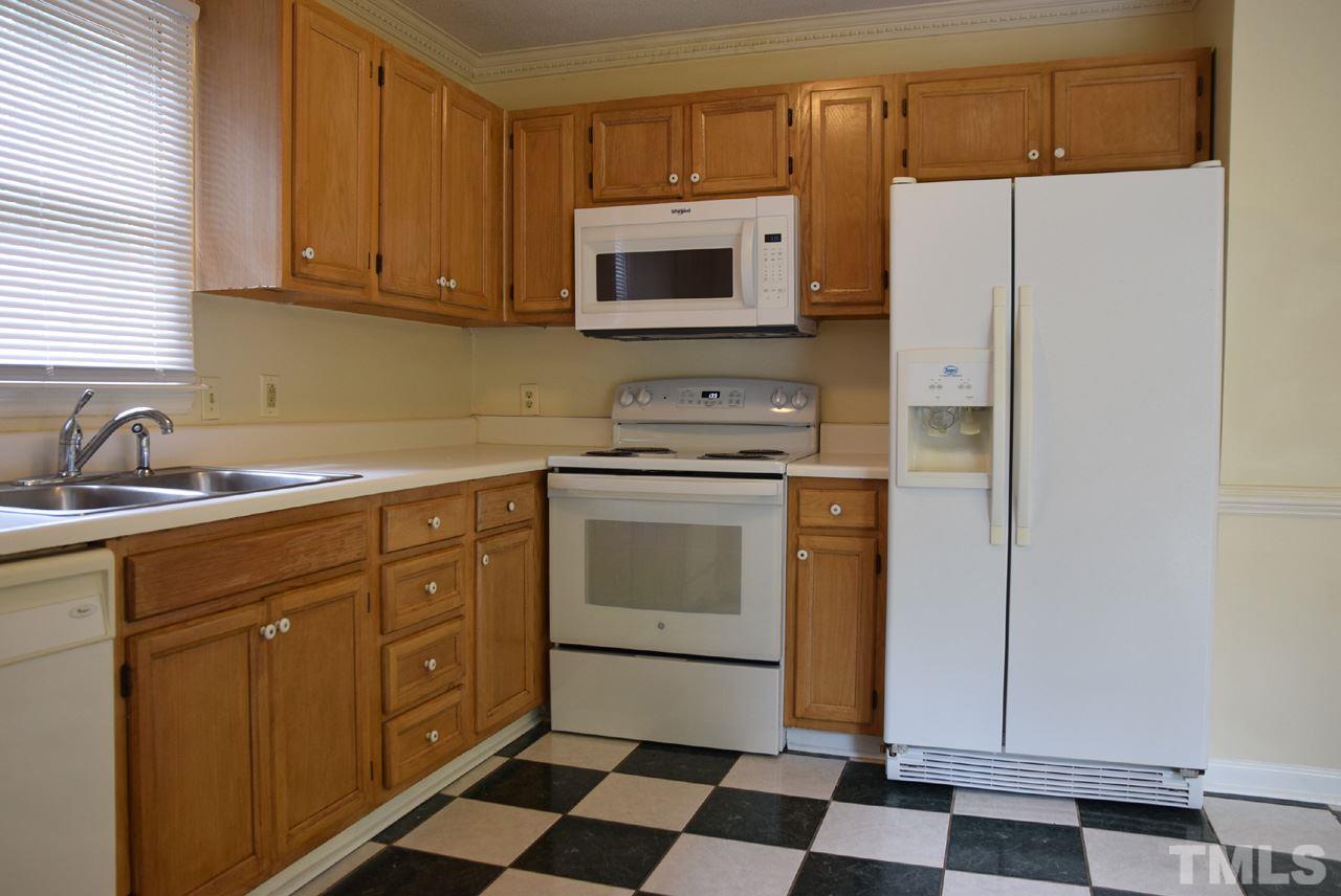 4608 Thurmount Place Raleigh, NC 27604 - Photo 8 of 30 a kitchen with a stove microwave and sink