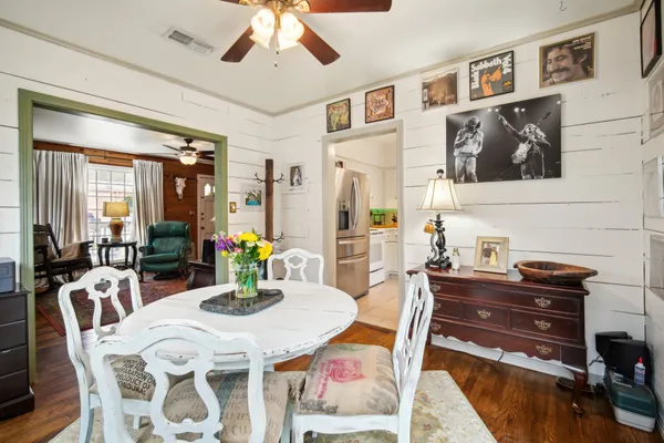 a view of a dining room with furniture and a kitchen
