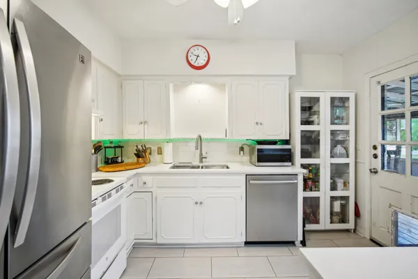 a kitchen with a sink and a refrigerator