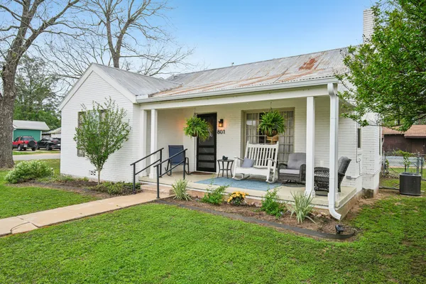 a view of a house with backyard porch and sitting area