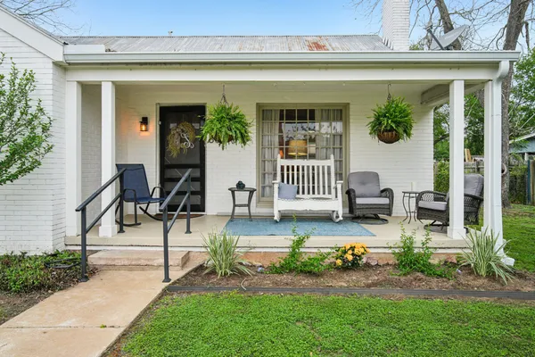 a view of a house with outdoor seating space