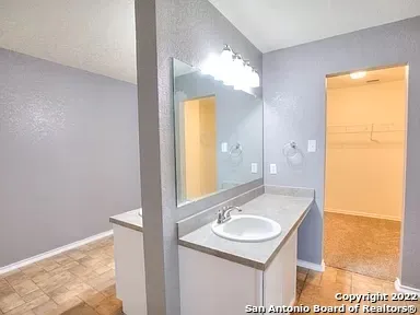 a bathroom with a sink and a mirror