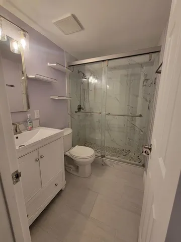a bathroom with a toilet sink and shower
