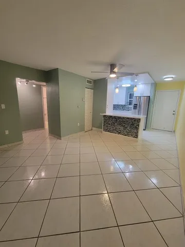 a spacious bathroom with a mirror and a shower