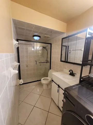 a bathroom with a sink a toilet and mirror