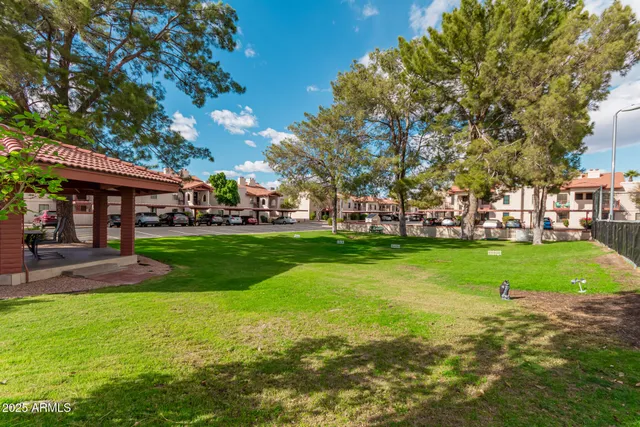a view of yard with swimming pool and green space