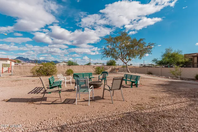 a view of a patio with a table and chairs