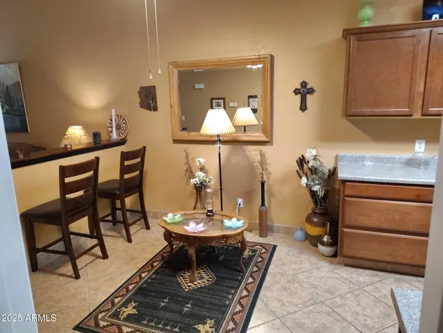 a living room with a table chairs and a dresser