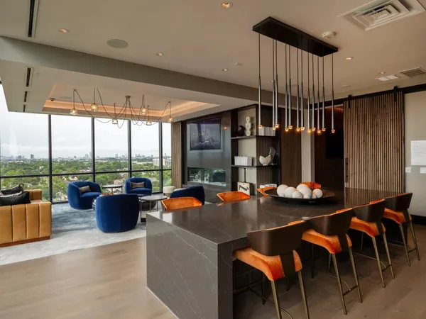 a dining room with furniture and a potted plant