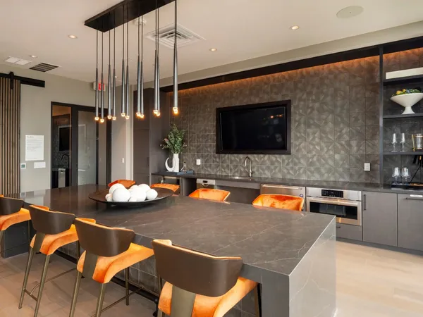 a living room with patio furniture and a flat screen tv