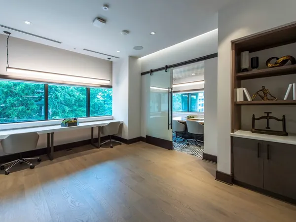 a living room with furniture and a floor to ceiling window