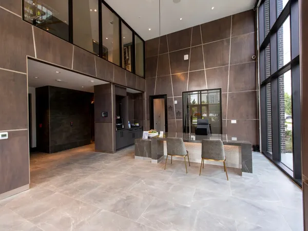 a living room with furniture and a floor to ceiling window