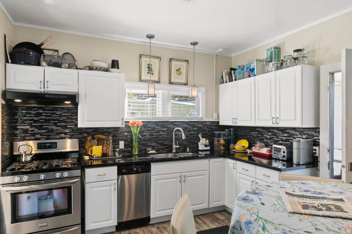 3 Ocean Avenue Carmel, CA 93921 - Photo 13 of 16 a kitchen with stainless steel appliances granite countertop a stove a sink and a microwave