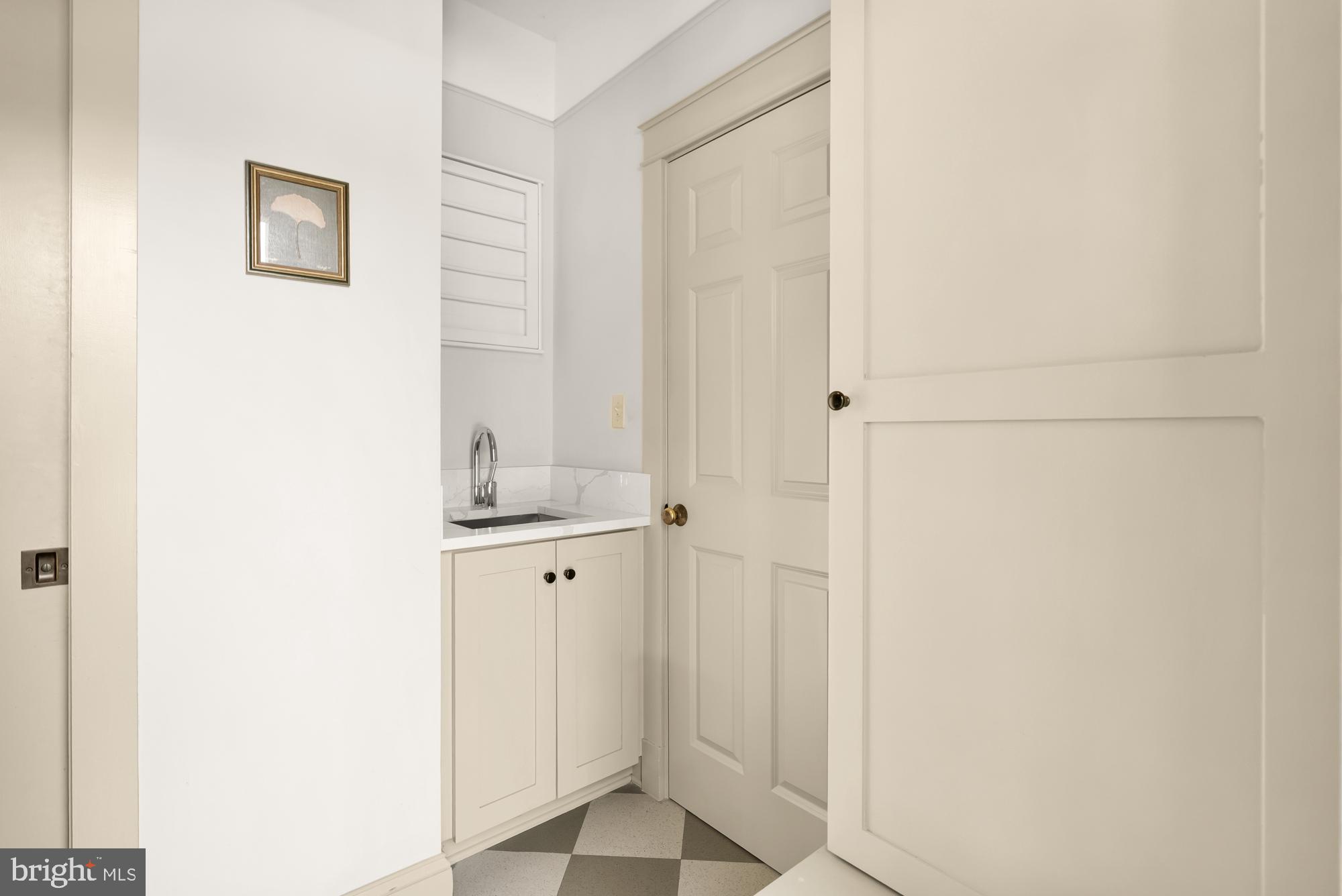 4111 18th Road North, Unit 1 Arlington, VA 22207 - Photo 13 of 16 a bathroom with a granite countertop sink and a mirror