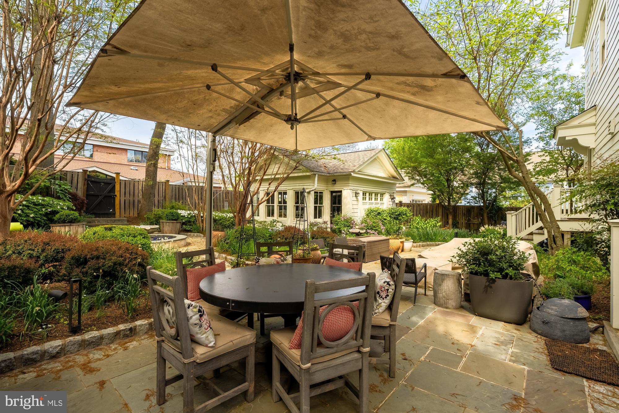 4111 18th Road North, Unit 1 Arlington, VA 22207 - Photo 14 of 16 a backyard of a house with table and chairs under an umbrella