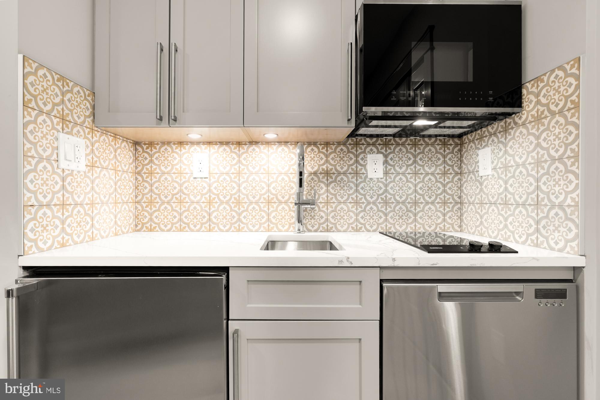 4111 18th Road North, Unit 1 Arlington, VA 22207 - Photo 4 of 16 a kitchen with a sink and a microwave