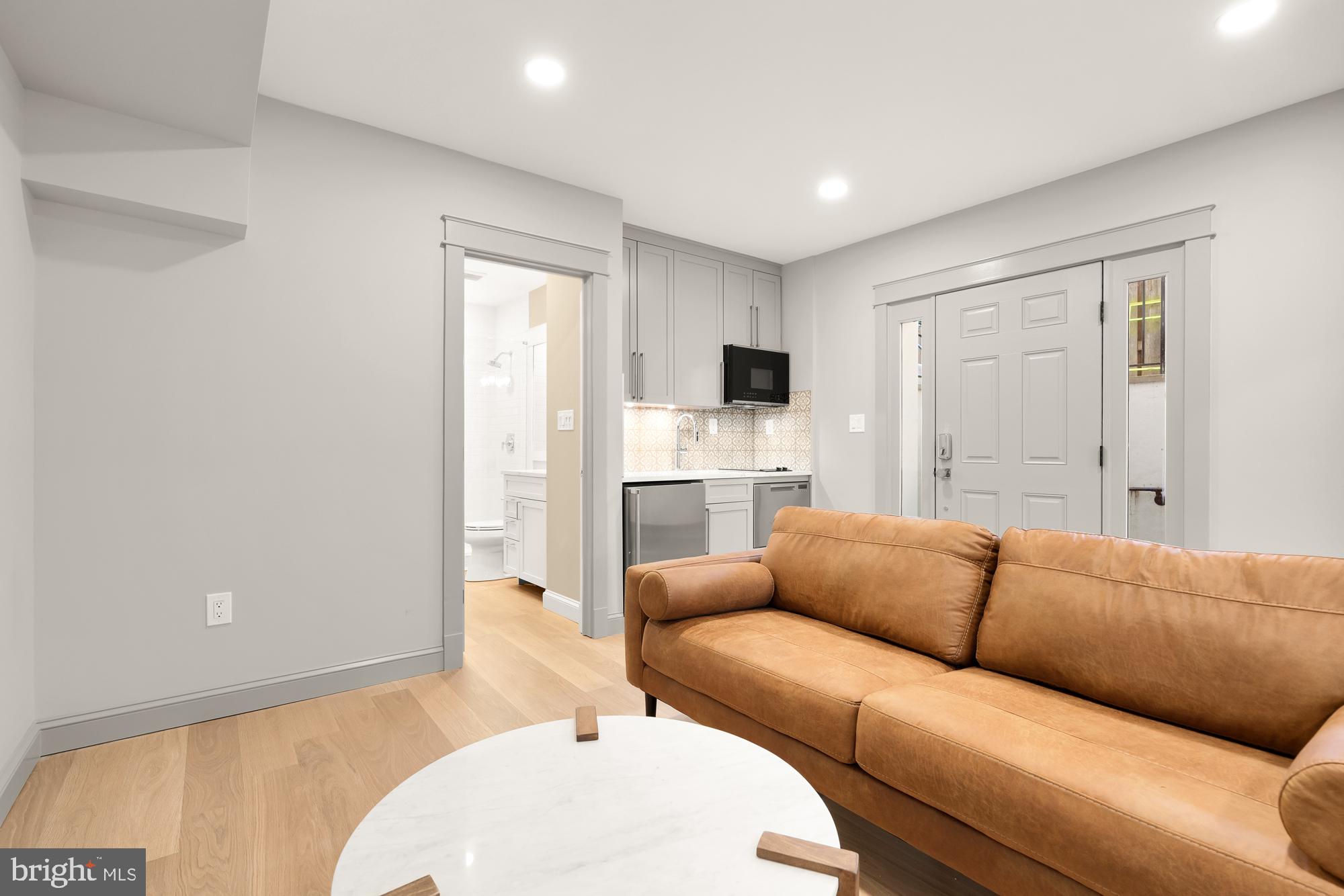 4111 18th Road North, Unit 1 Arlington, VA 22207 - Photo 5 of 16 a living room with furniture a fireplace and a flat screen tv