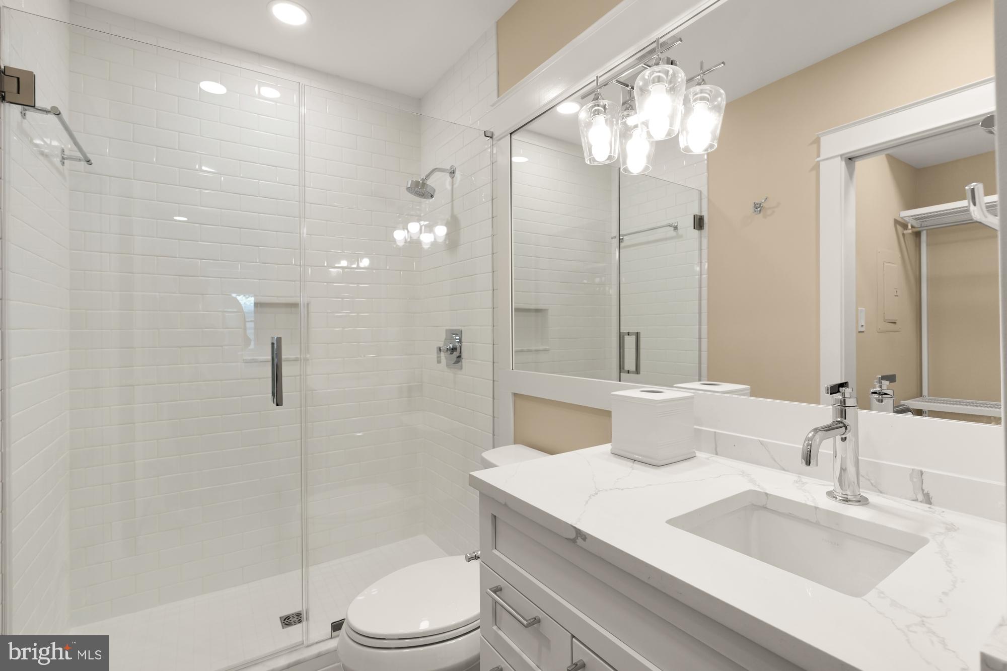 4111 18th Road North, Unit 1 Arlington, VA 22207 - Photo 9 of 16 a bathroom with a sink a toilet and shower