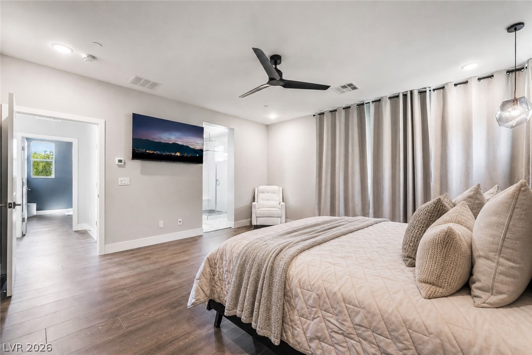 2166 Trivero Street Henderson, NV 89044 - Photo 27 of 61 Elegant primary bedroom offers a spacious layout and direct access to a modern shower.