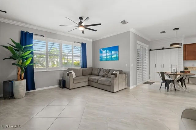 a living room with furniture and a potted plant