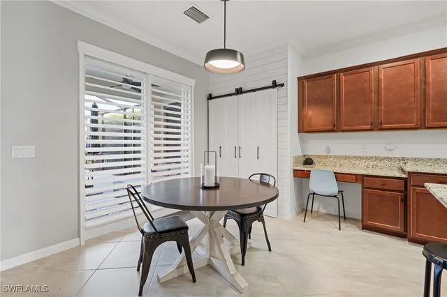 a dining room with furniture and window