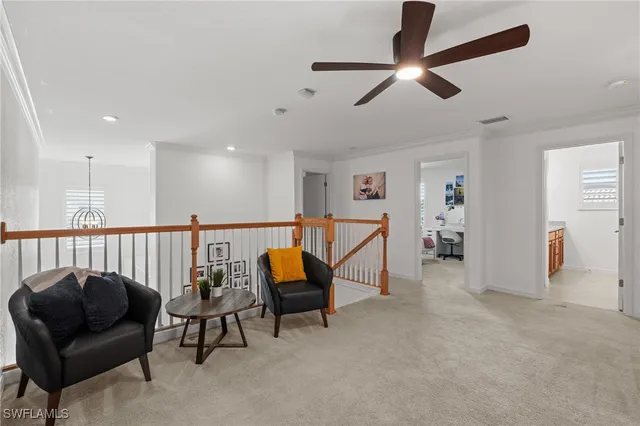 a living room with furniture and a ceiling fan