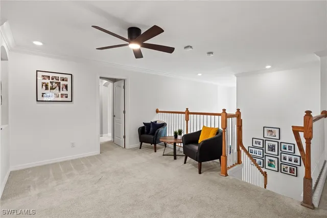 a view of a livingroom with furniture and a ceiling fan
