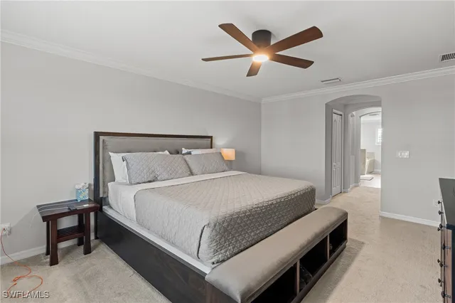 a bedroom with a bed a ceiling fan and a dresser