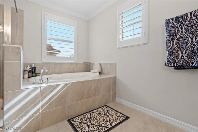 a bathroom with a bathtub and next to a window