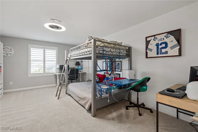 a view of a livingroom with workspace and a window