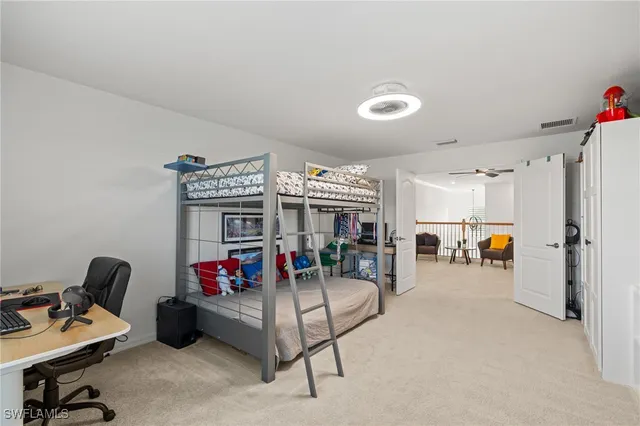 a view of a livingroom with furniture and a ceiling fan