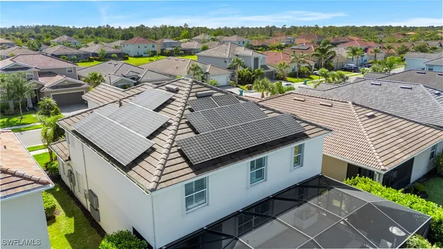 an aerial view of a house with a mountain