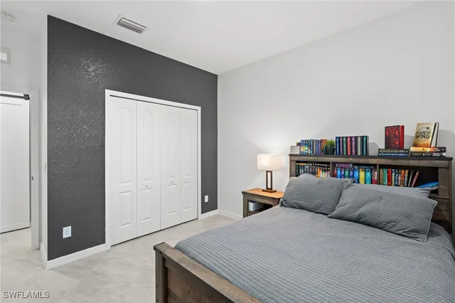a bed room with a bed and a book shelf